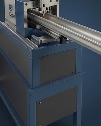 Seamless gutter being rolled to length on an on-site gutter forming machine